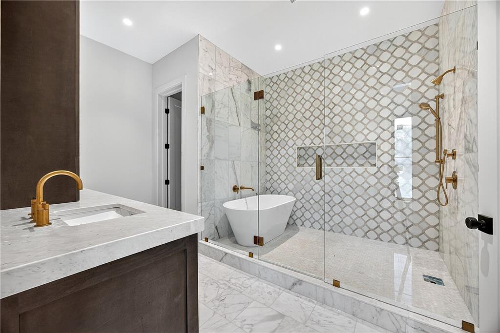 1366 Wessyngton Road Northeast Atlanta, GA 30306 - Photo 13 of 29 a bathroom with a bathtub sink mirror and toilet