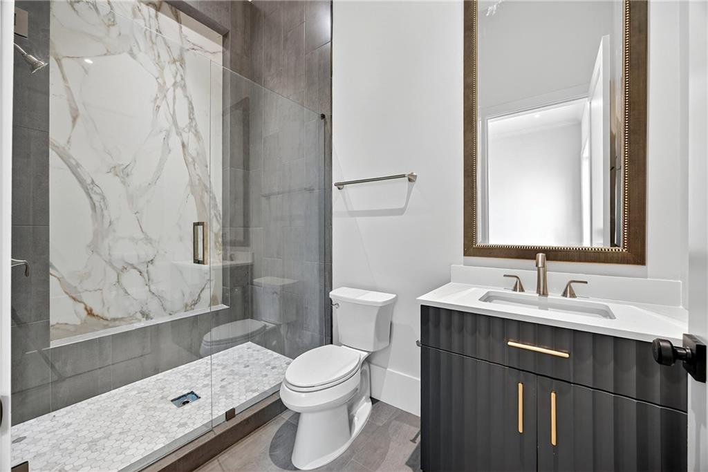 1366 Wessyngton Road Northeast Atlanta, GA 30306 - Photo 18 of 29 a bathroom with a sink a toilet and shower curtain
