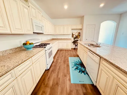 a stove top oven sitting inside of a kitchen