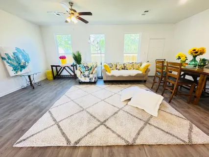 a livingroom with furniture and a wooden floor