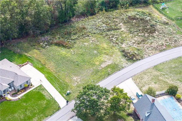 a view of a yard with wooden fence