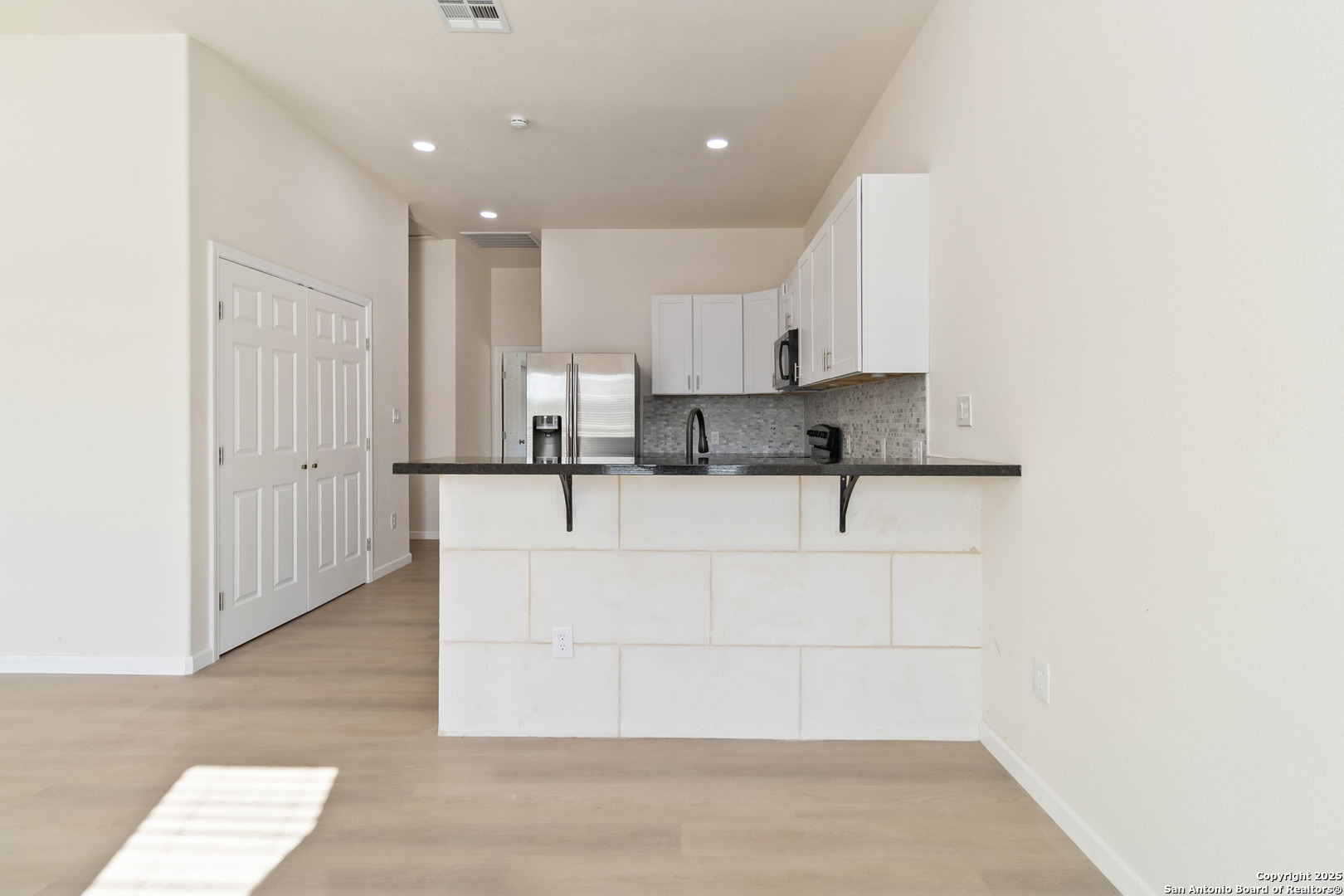 324 Ridgerock Drive, Unit 1 Canyon Lake, TX 78133 - Photo 7 of 21 a view of kitchen with granite countertop white cabinets and stainless steel appliances