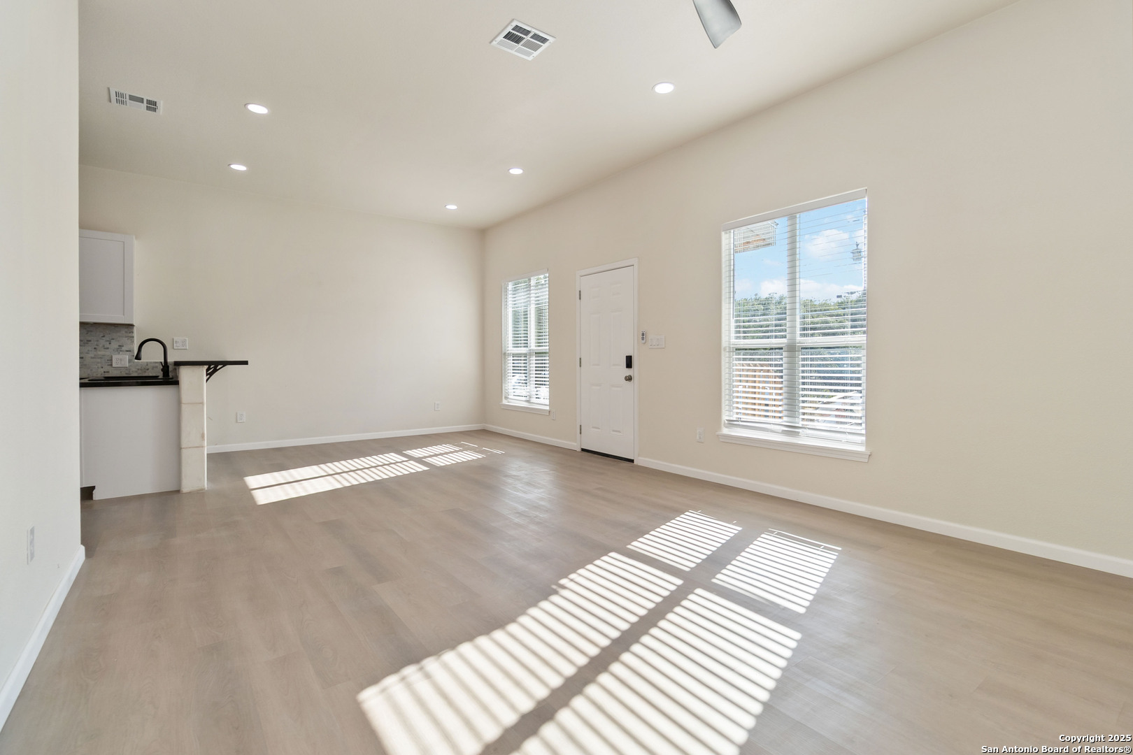 324 Ridgerock Drive, Unit 1 Canyon Lake, TX 78133 - Photo 8 of 21 an empty room with windows and pillars in it