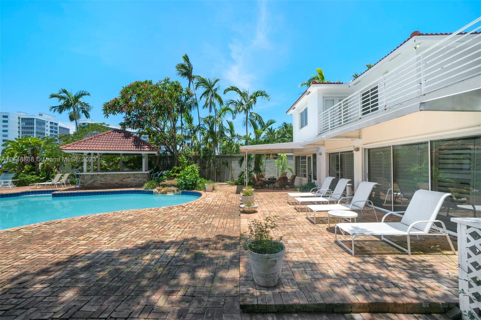 9224 Bay Drive Surfside, FL 33154 - Photo 10 of 11 a view of a house with backyard porch and sitting area