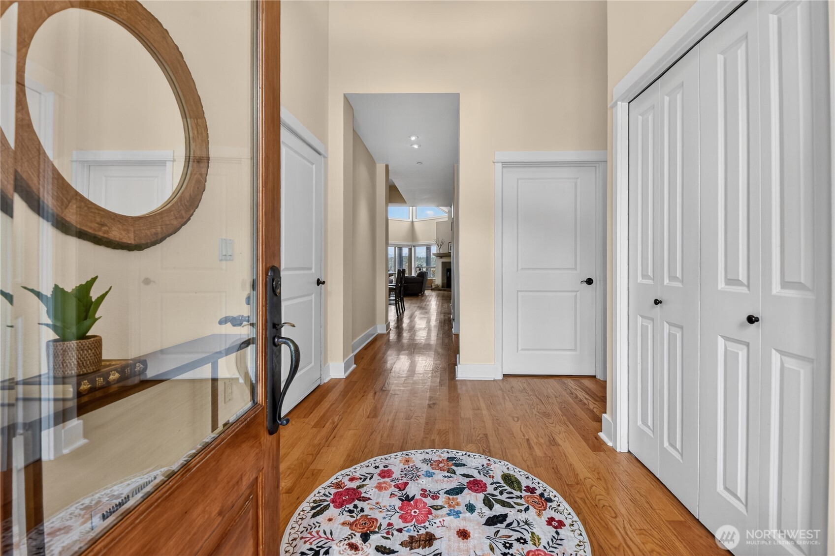 383 Romance Hill Road, Unit C Belfair, WA 98528 - Photo 3 of 25 a view of a hallway with wooden floor and a dining room