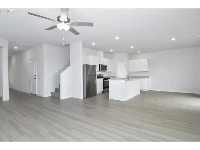a view of kitchen with refrigerator and window