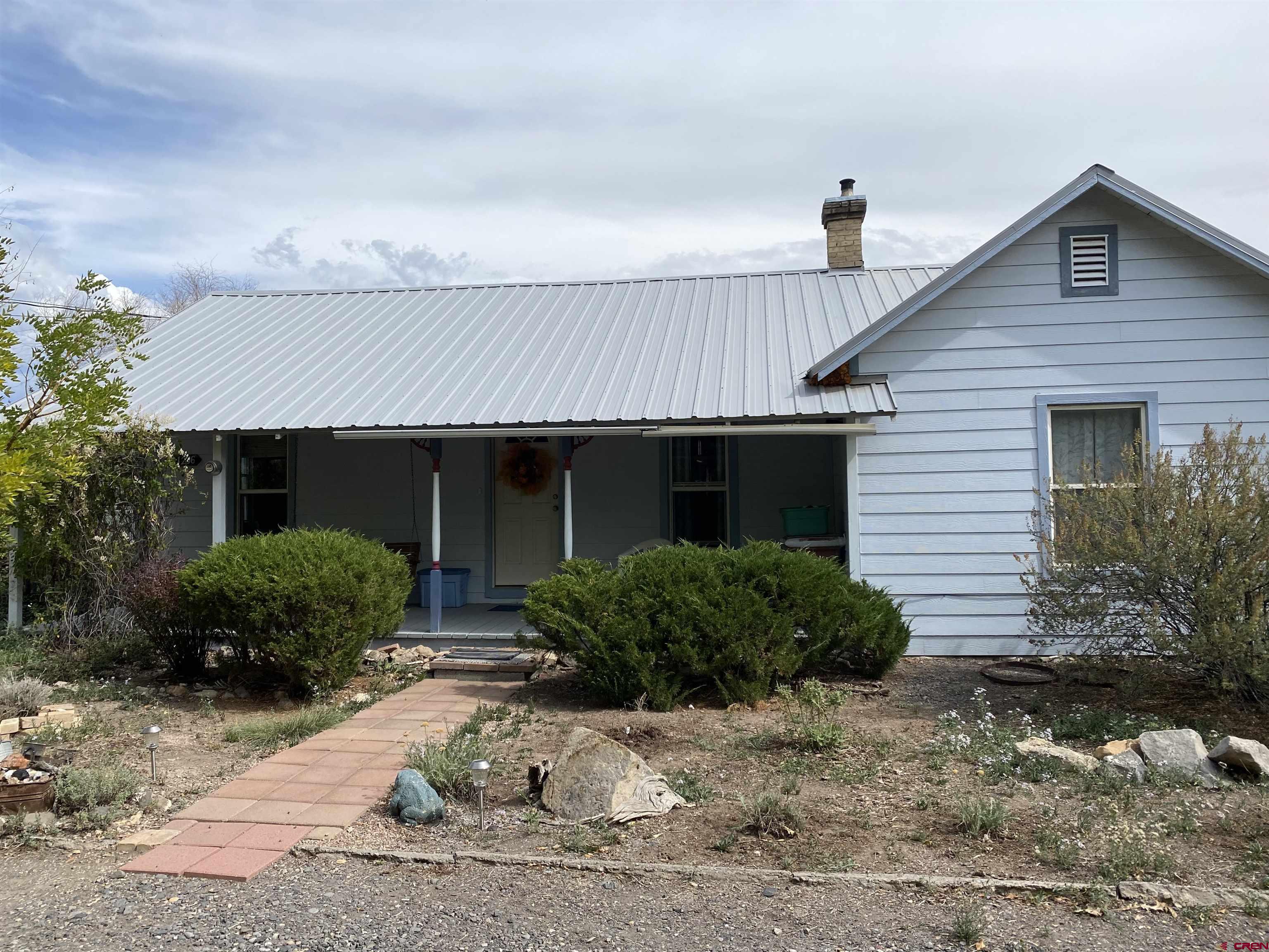 21236 Lanning Road Austin, CO 81410 - Photo 2 of 21 a front view of a house with garden