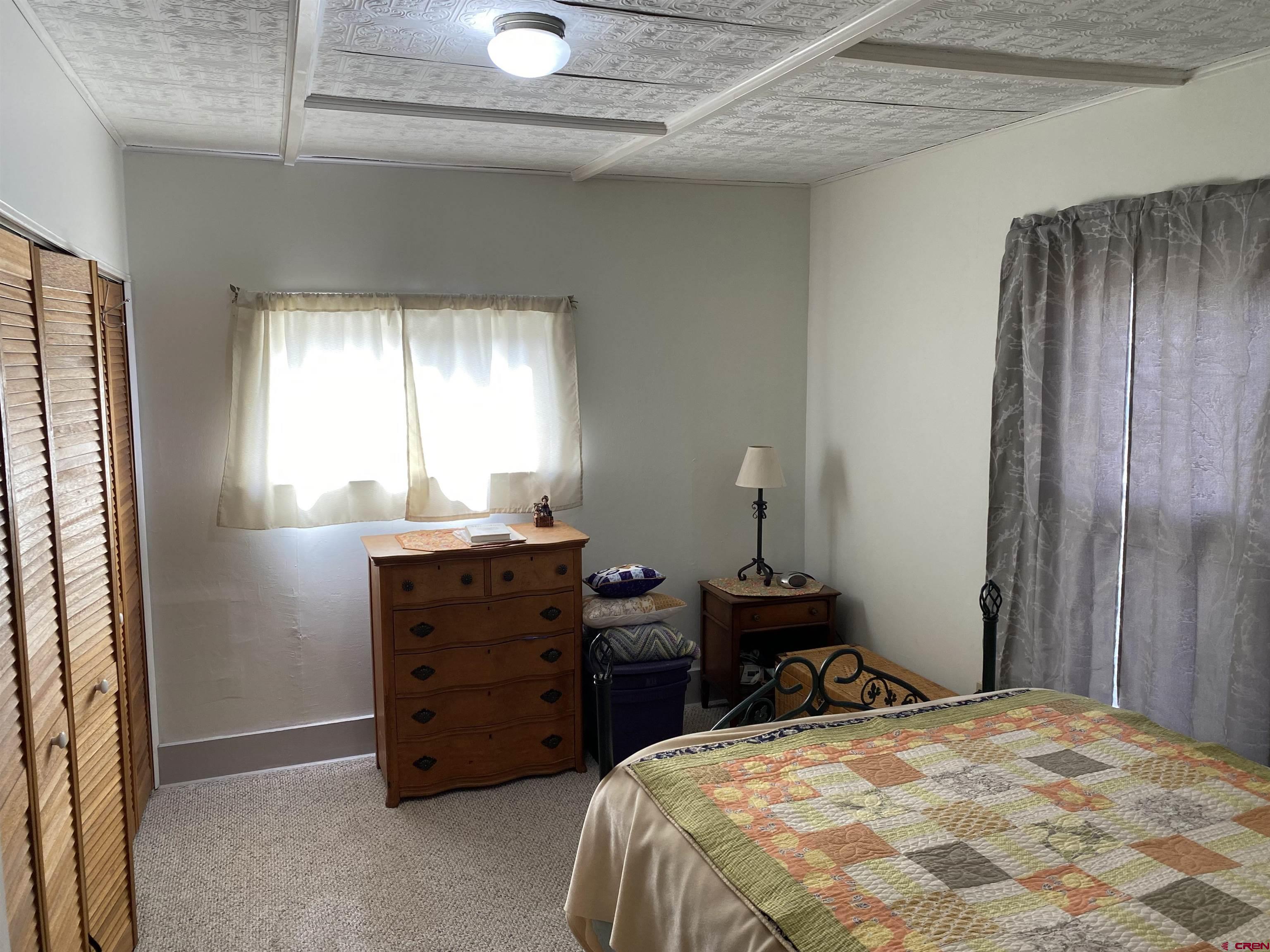 21236 Lanning Road Austin, CO 81410 - Photo 12 of 21 a bedroom with a bed and a closet