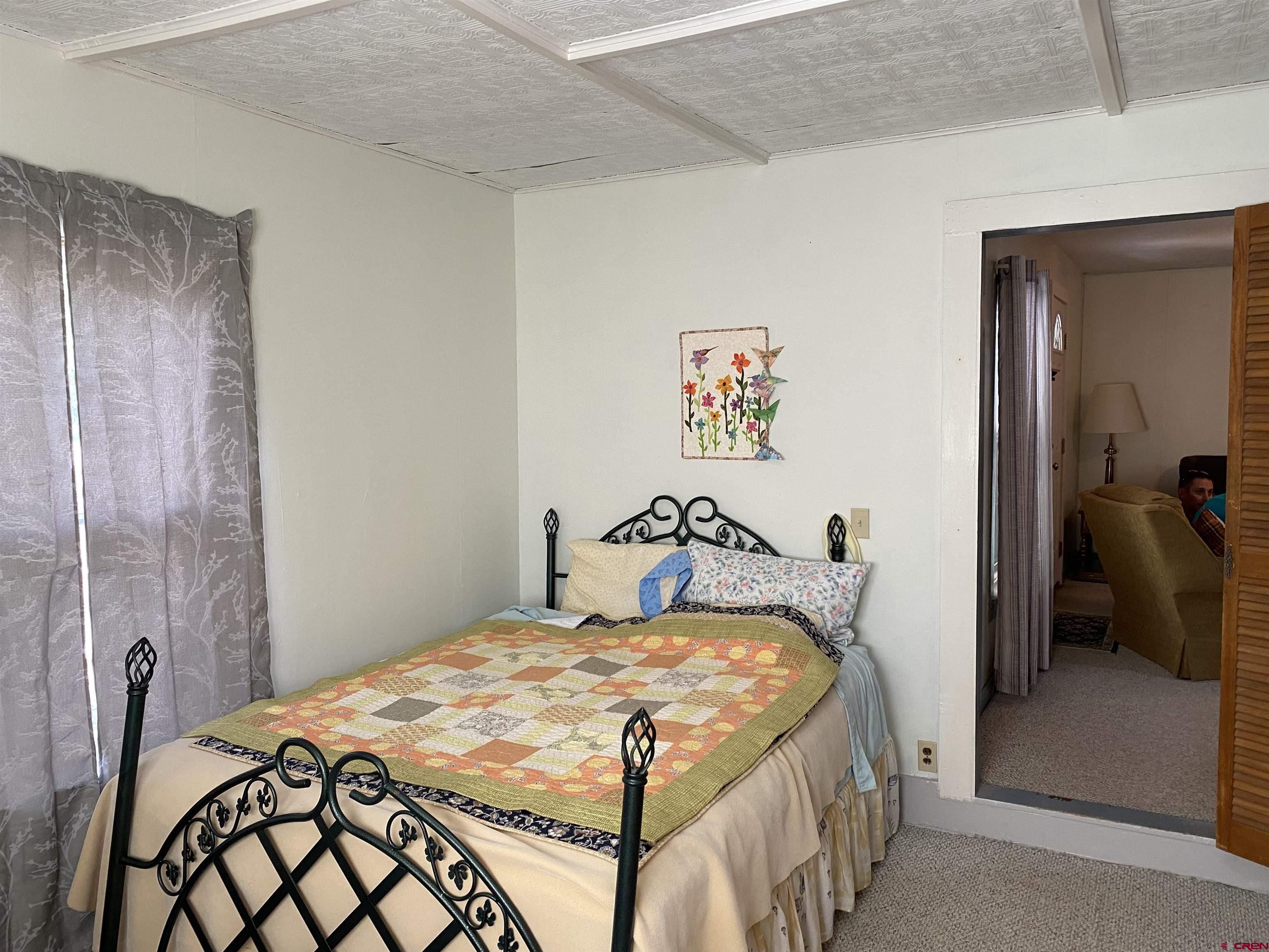 21236 Lanning Road Austin, CO 81410 - Photo 13 of 21 a bedroom with a bed and a table in it