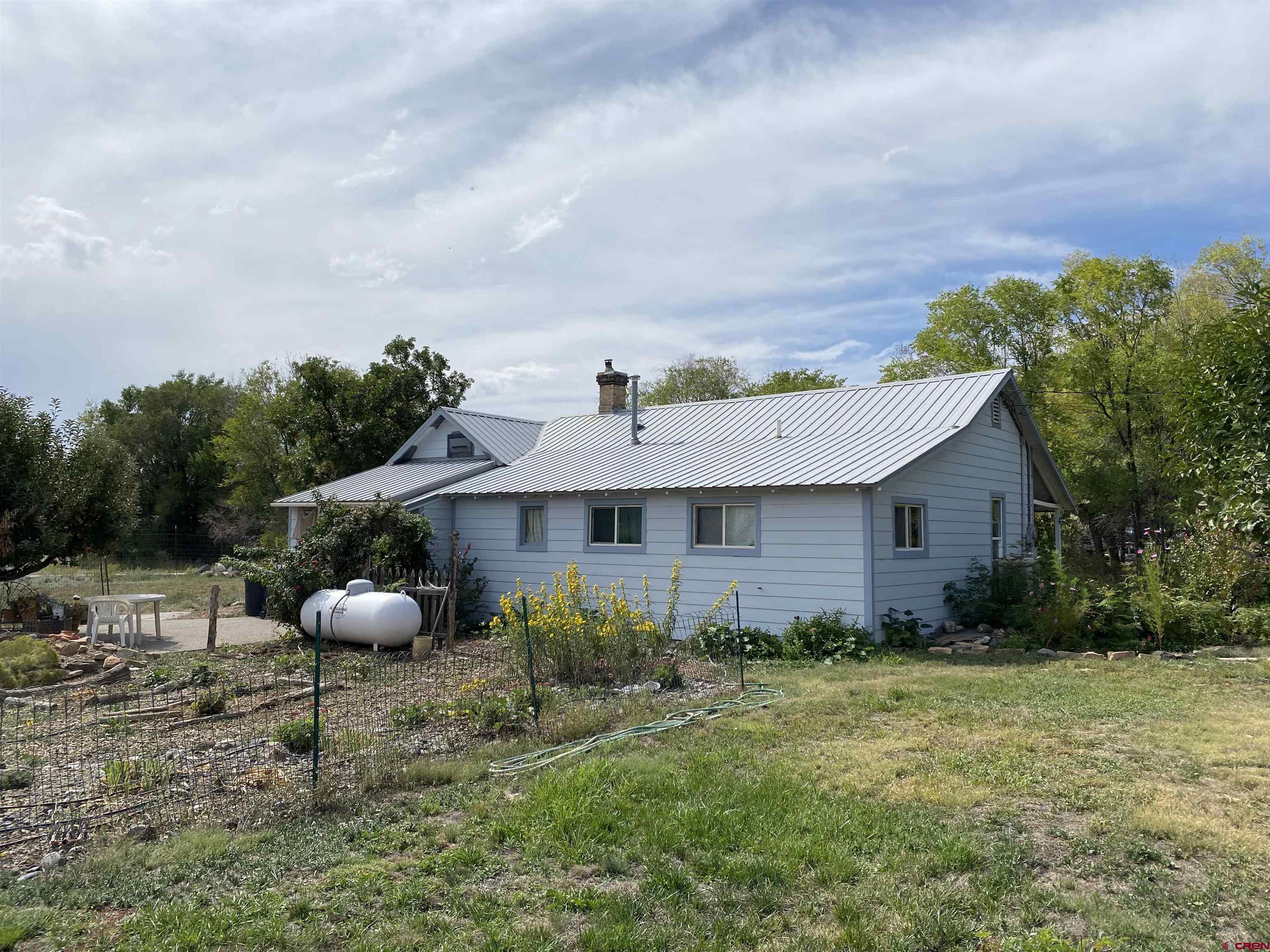 21236 Lanning Road Austin, CO 81410 - Photo 20 of 21 a backyard of a house with table and chairs