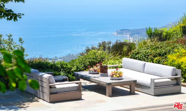 a outdoor living space with furniture and city view