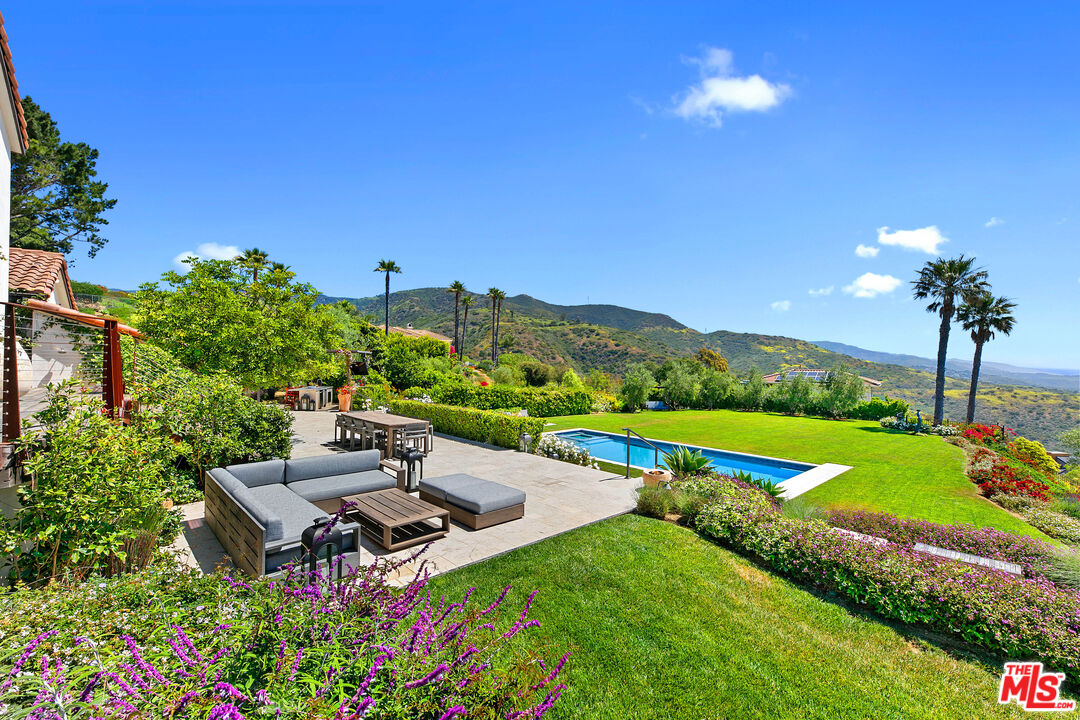 27450 Calicut Road Malibu, CA 90265 - Photo 27 of 59 a view of a patio with table and chairs and potted plants