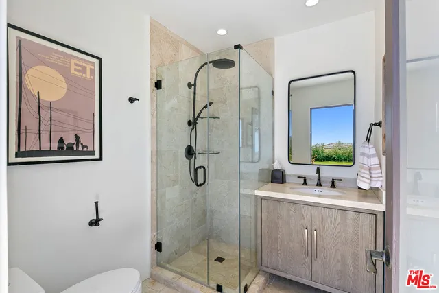 a bathroom with a bathtub sink and mirror