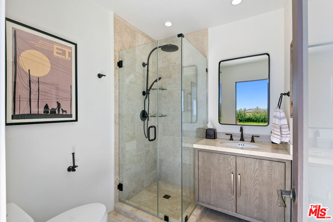27450 Calicut Road Malibu, CA 90265 - Photo 35 of 59 a bathroom with a double vanity sink toilet and shower