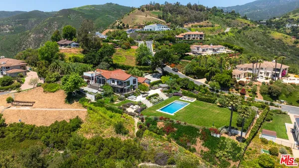 a bathroom with a bathtub a sink and a large window