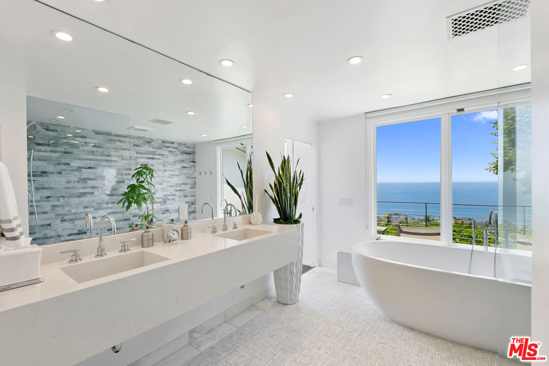 27450 Calicut Road Malibu, CA 90265 - Photo 40 of 59 a bathroom with a bathtub a sink and a large window
