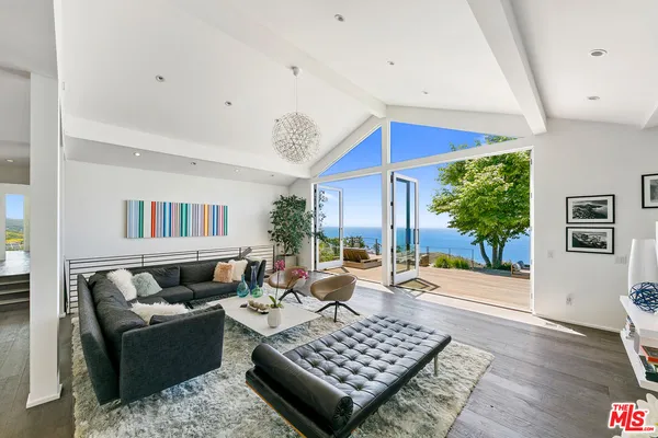 a dining hall with stainless steel appliances granite countertop a dining table and chairs with wooden floor