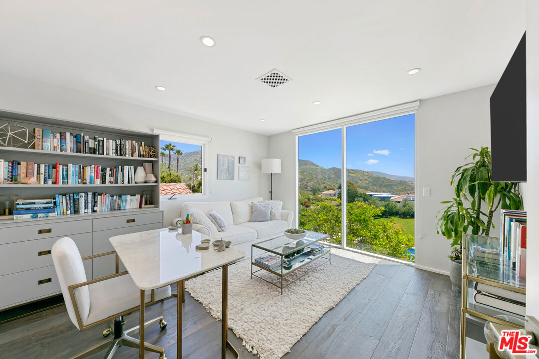 27450 Calicut Road Malibu, CA 90265 - Photo 42 of 59 a living room with furniture large window and wooden floor