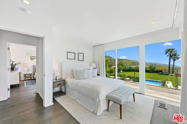 a bedroom with a large bed and a large window