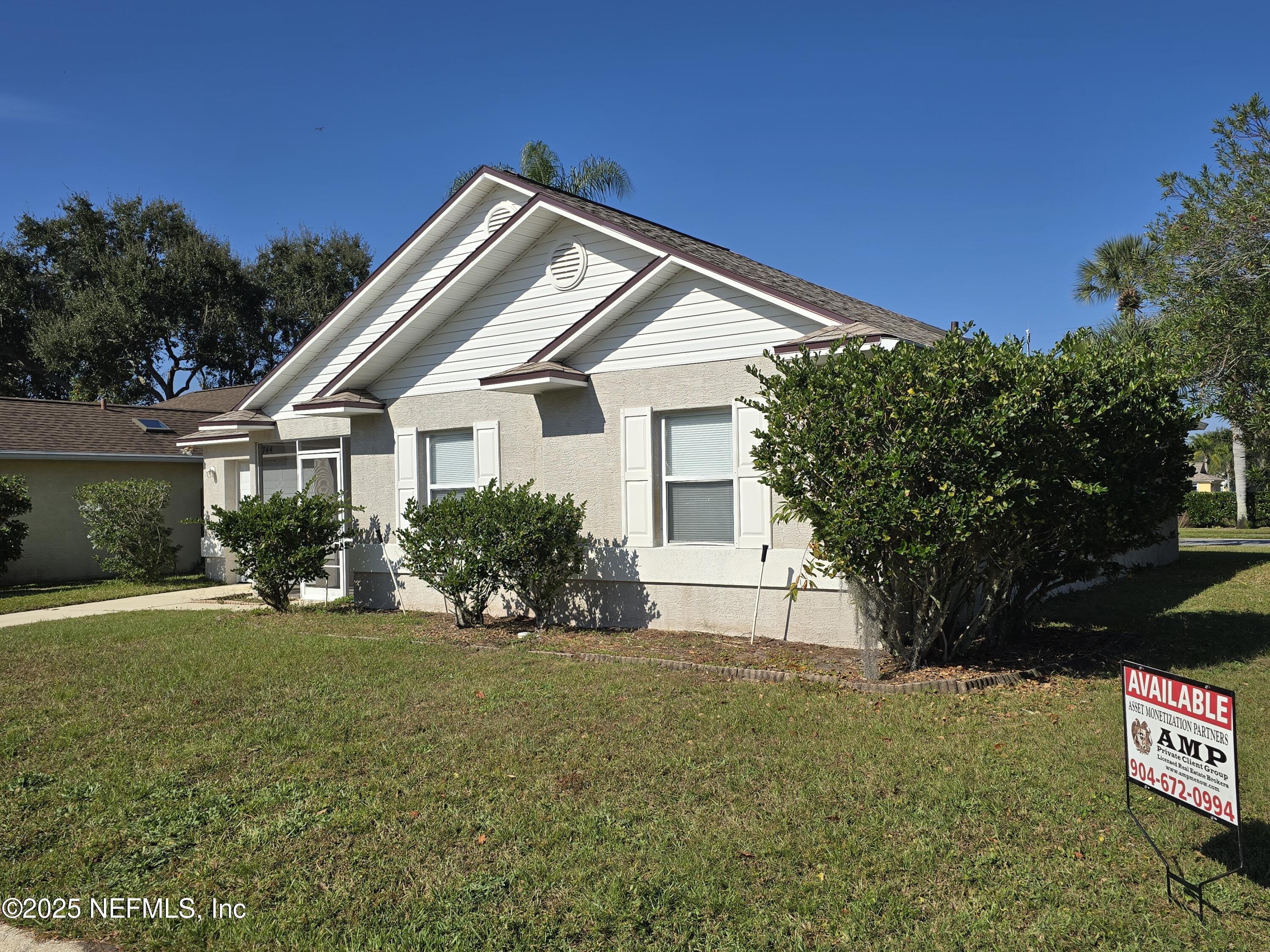 744 Palm Hammock Circle St. Augustine, FL 32095 - Photo 1 of 34 a front view of a house with a yard
