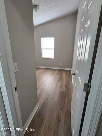 a view of a room with wooden floor and staircase
