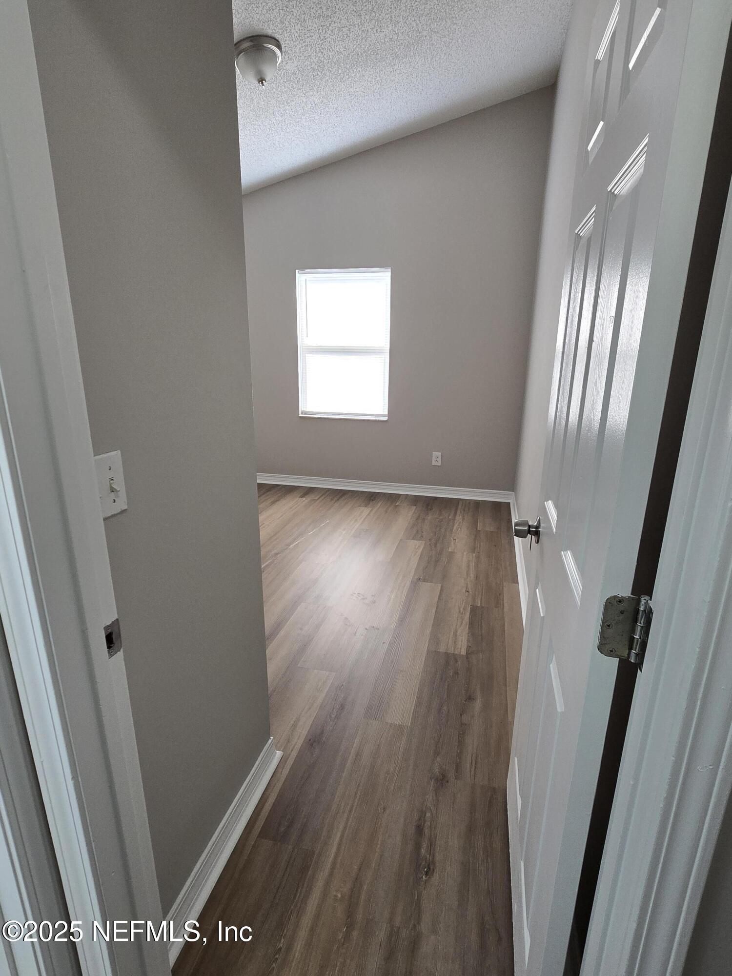 744 Palm Hammock Circle St. Augustine, FL 32095 - Photo 16 of 34 a view of a room with wooden floor and staircase
