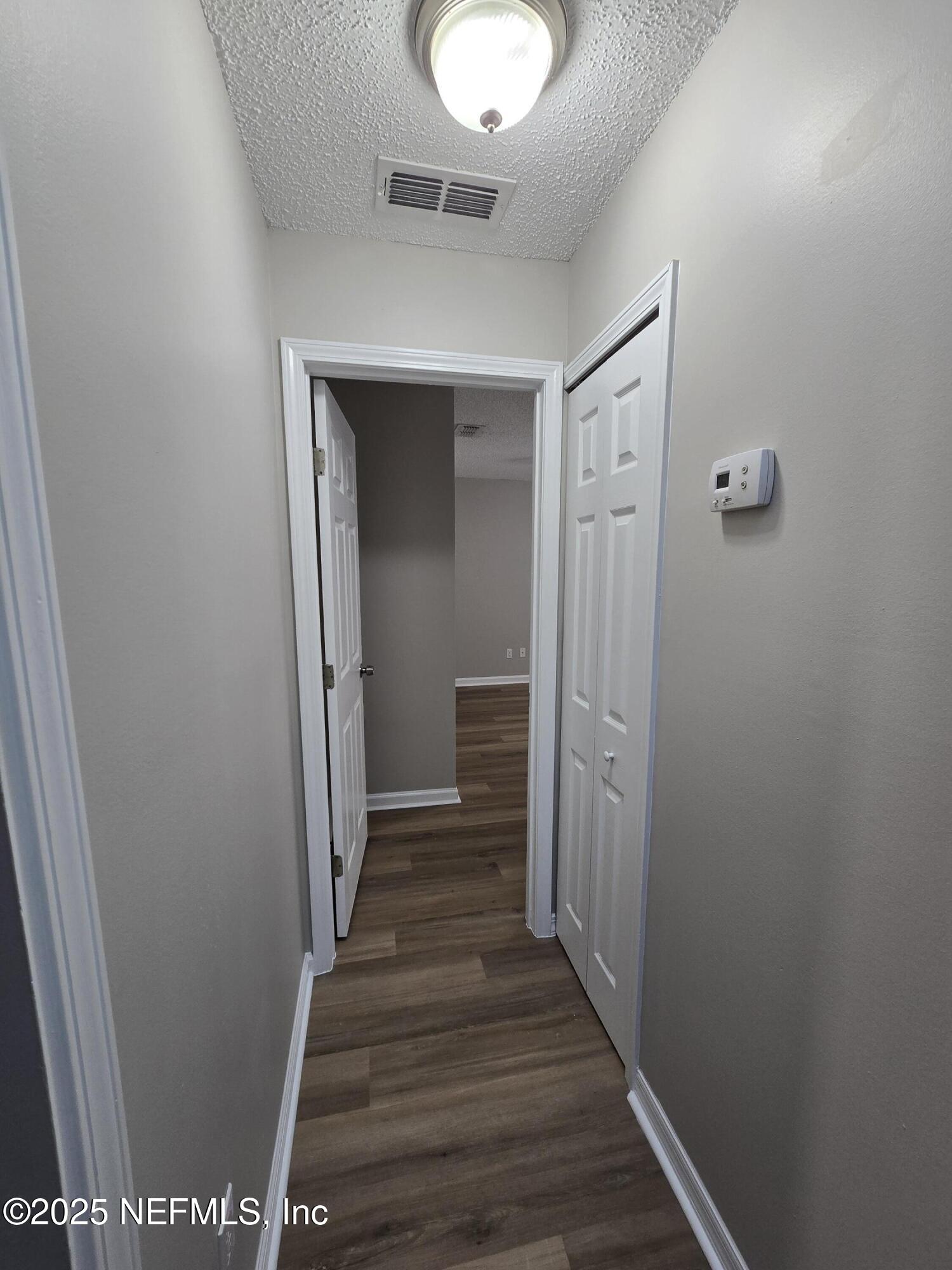 744 Palm Hammock Circle St. Augustine, FL 32095 - Photo 29 of 34 a view of a hallway with wooden floor and staircase