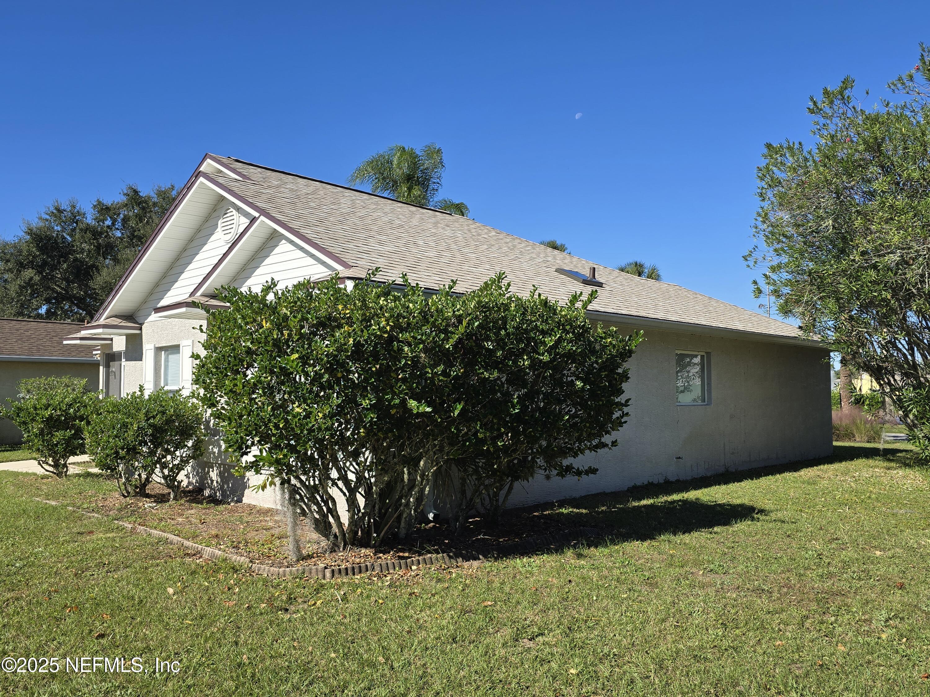 744 Palm Hammock Circle St. Augustine, FL 32095 - Photo 3 of 34 a backyard of a house with lots of green space