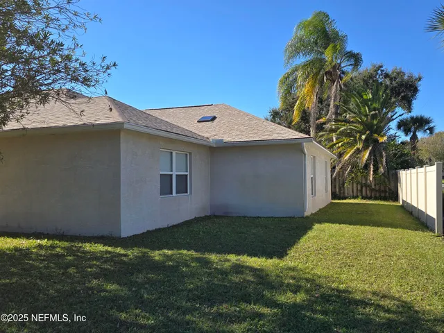 a front view of house with yard and trees