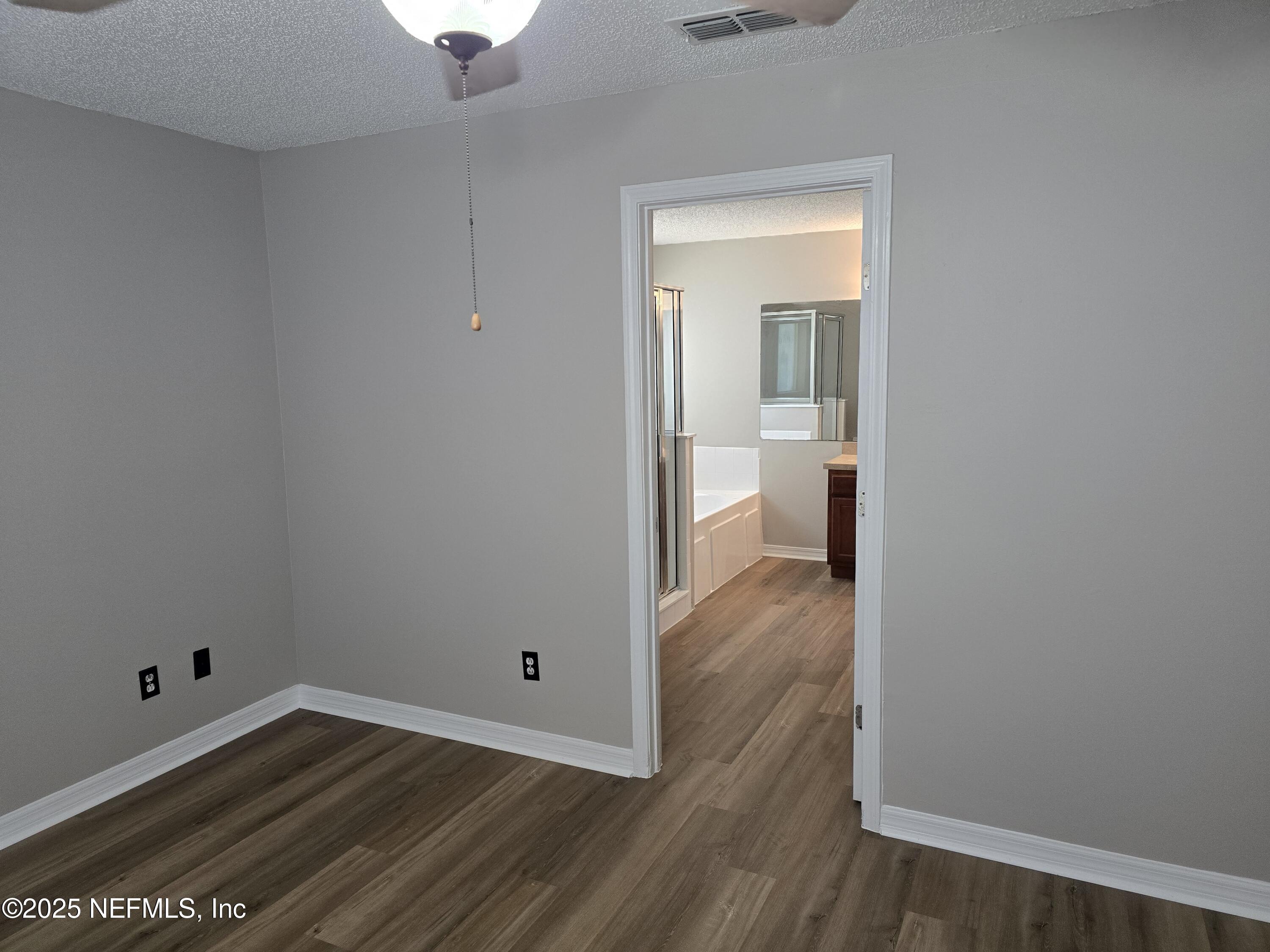744 Palm Hammock Circle St. Augustine, FL 32095 - Photo 6 of 34 a view of a room with wooden floor and a bathroom
