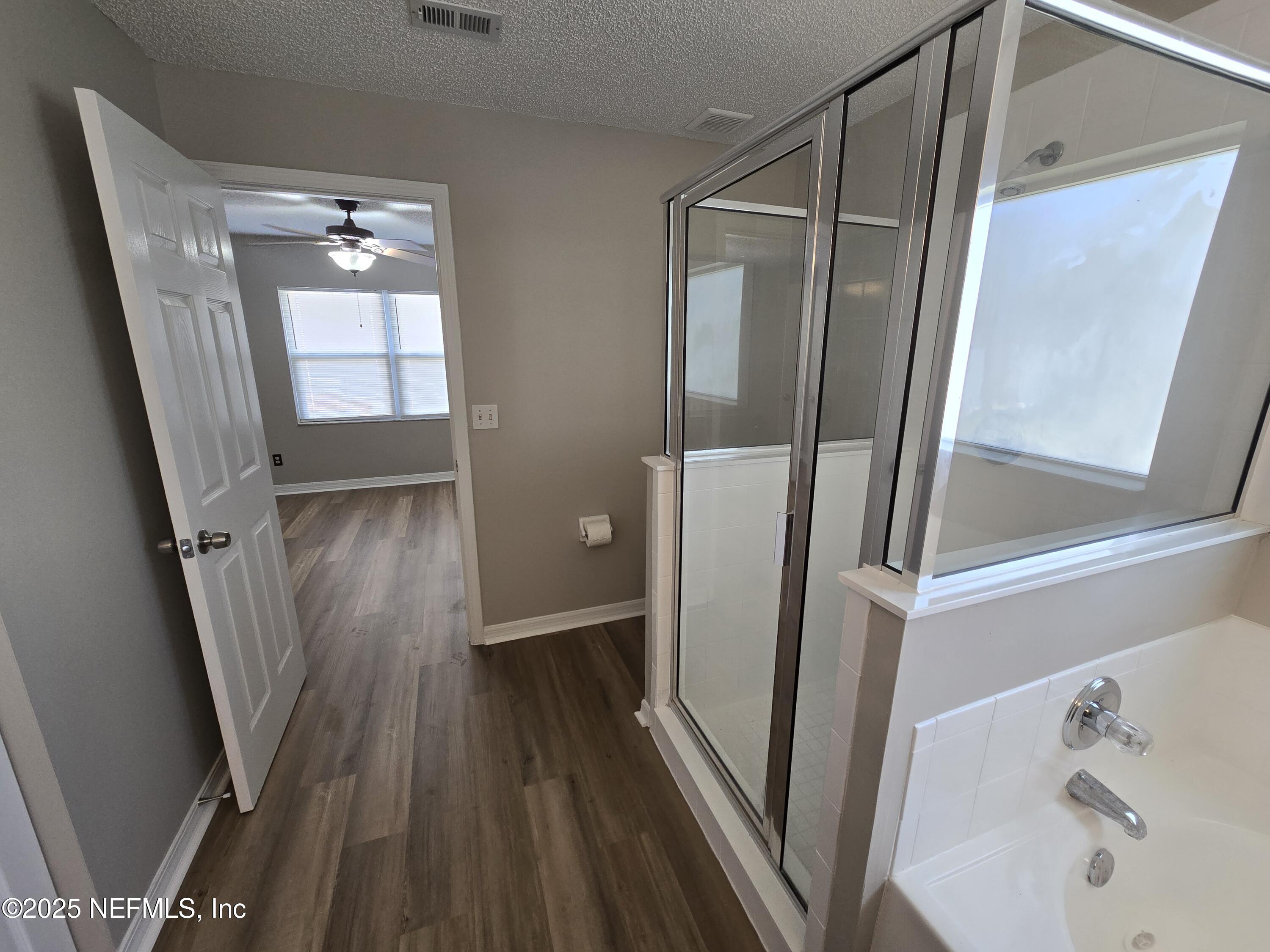 744 Palm Hammock Circle St. Augustine, FL 32095 - Photo 10 of 34 a view of a hallway with wooden floor and staircase