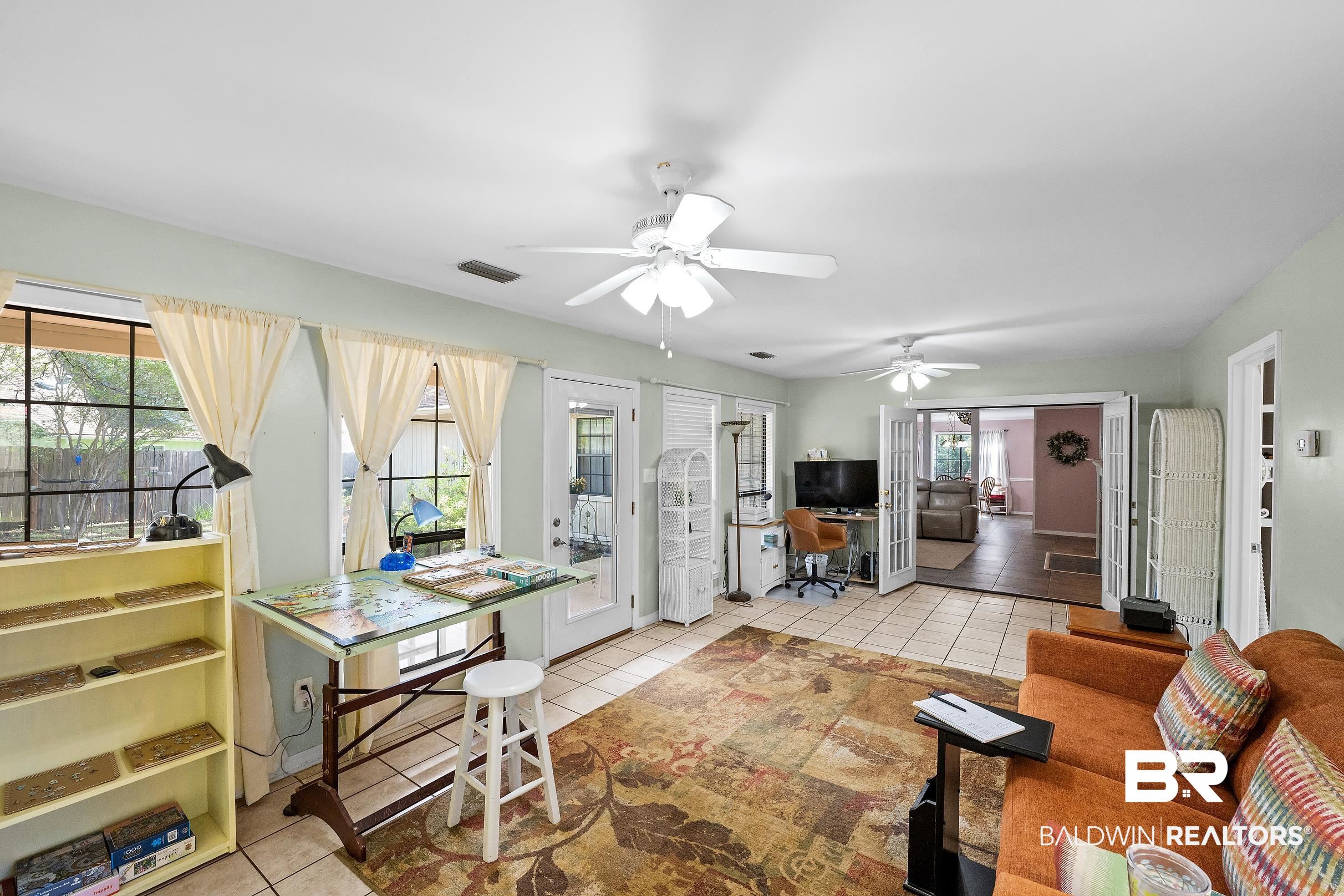 4026 Kingsrow Row Mobile, AL 36619 - Photo 29 of 51 Living room with a desk, light tile patterned floors, and a ceiling fan