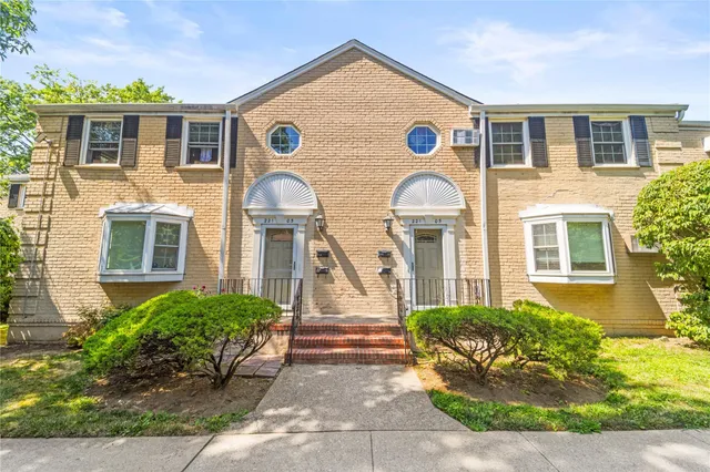 a view of a brick house with a yard