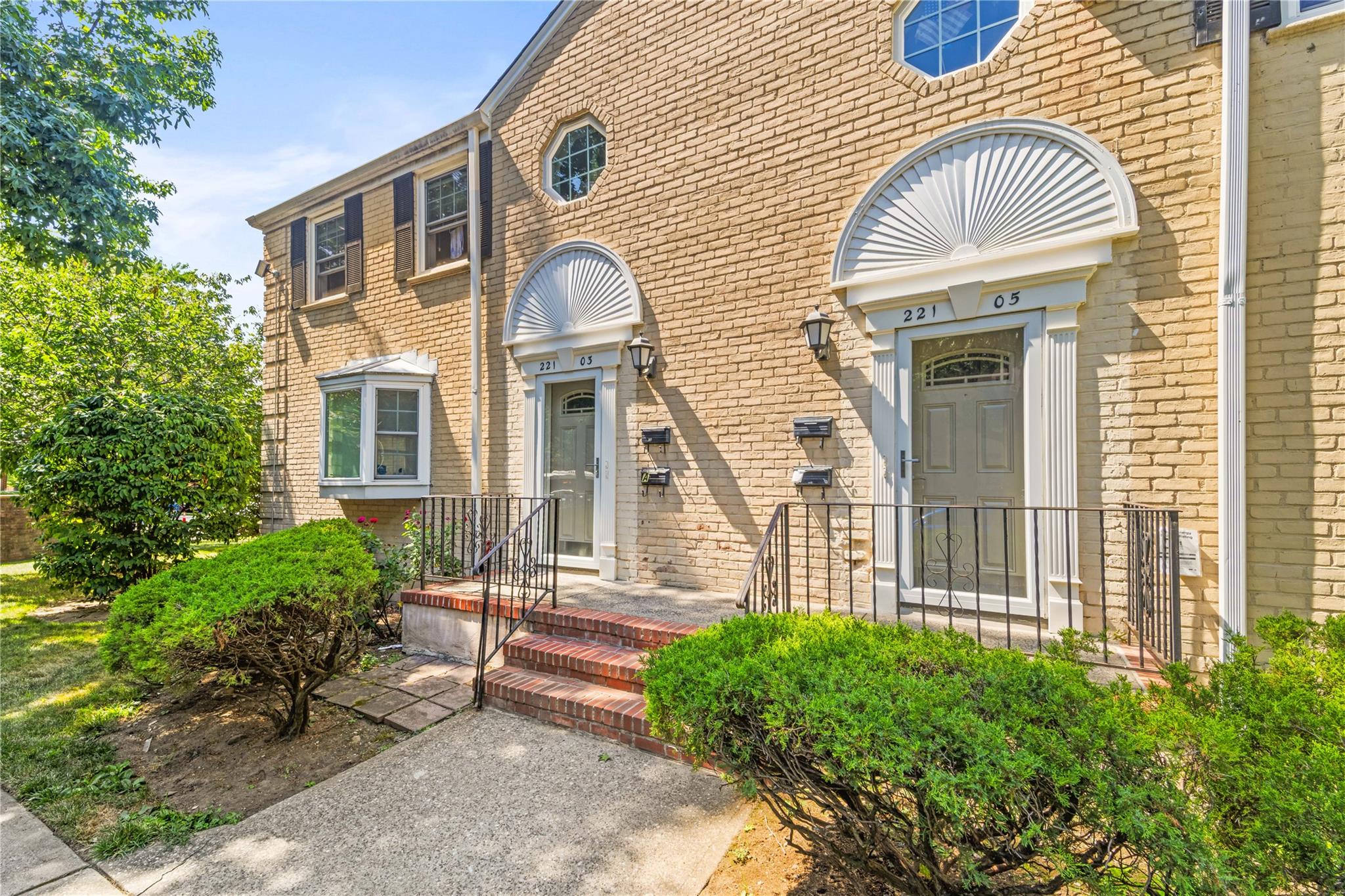 221-03 67th Avenue, Unit 1 Queens, NY 11364 - Photo 14 of 14 a front view of a house with a garden