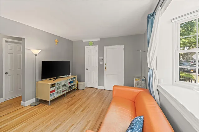 a bedroom with furniture and a flat screen tv