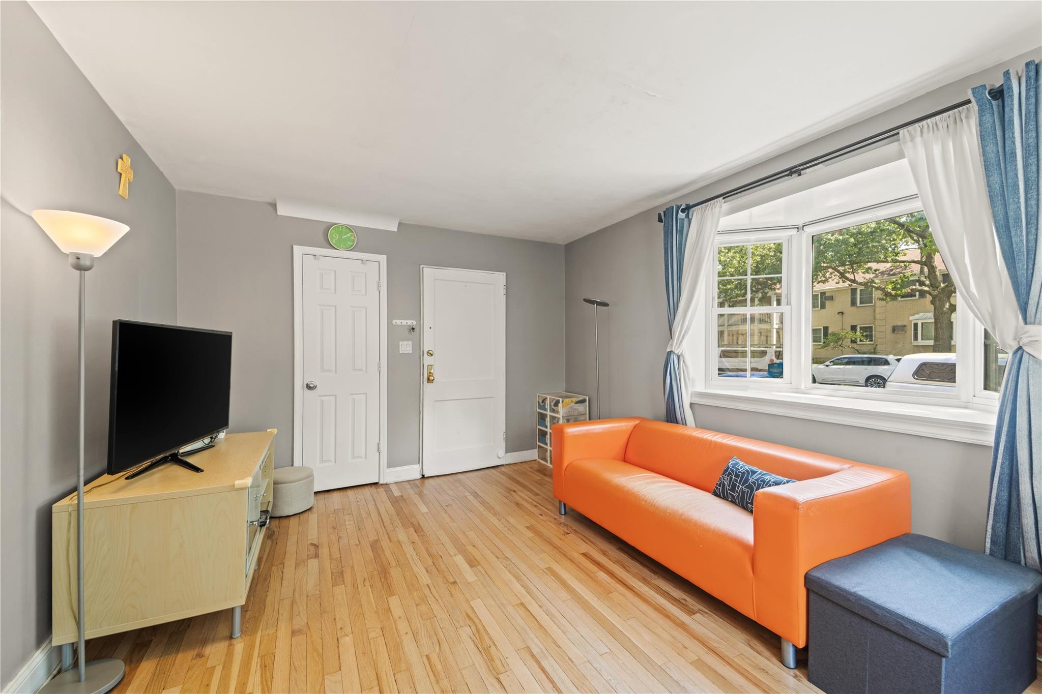 221-03 67th Avenue, Unit 1 Queens, NY 11364 - Photo 5 of 14 a bedroom with a bed and flat screen tv