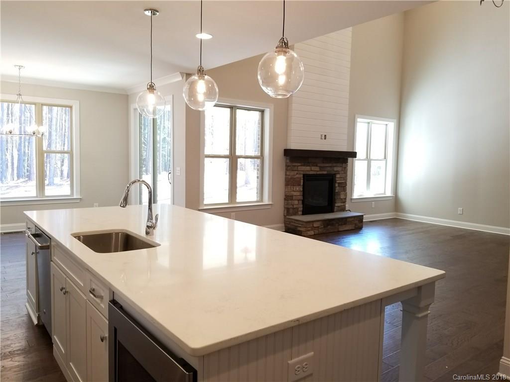 1094 Trinity Ridge Parkway, Unit 51 Fort Mill, SC 29715 - Photo 16 of 17 a large kitchen with kitchen island a sink stove and wooden floor