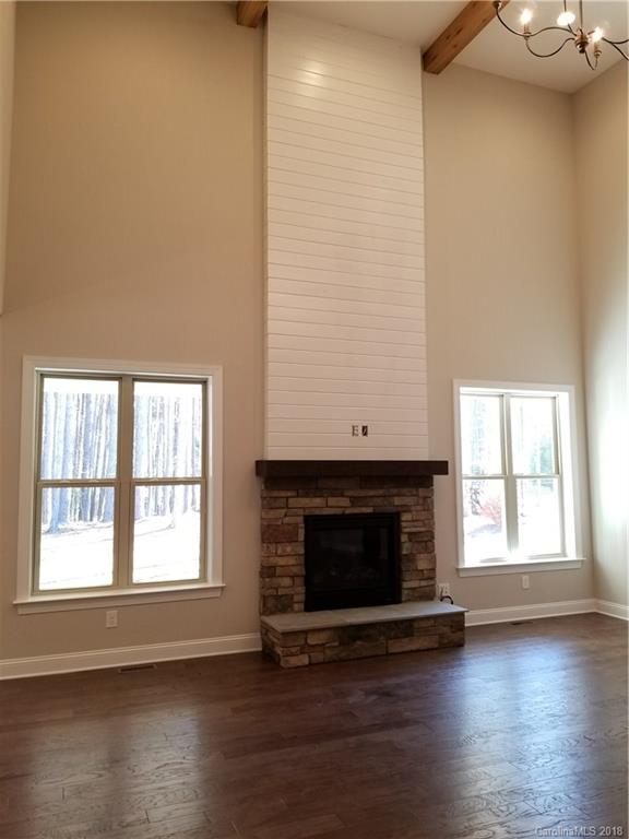 1094 Trinity Ridge Parkway, Unit 51 Fort Mill, SC 29715 - Photo 10 of 17 an empty room with wooden floor a fireplace and windows