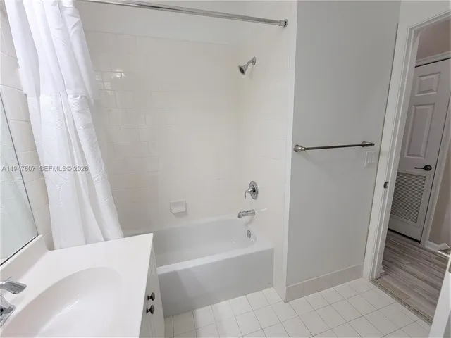 a bathroom with a bathtub and shower