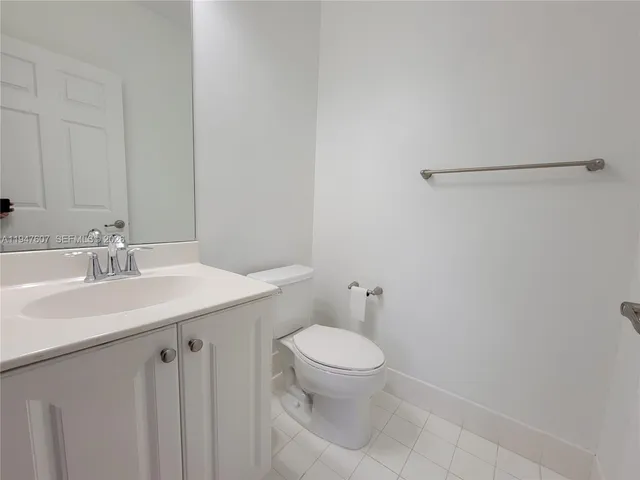 a bathroom with a sink a toilet a vanity and mirror