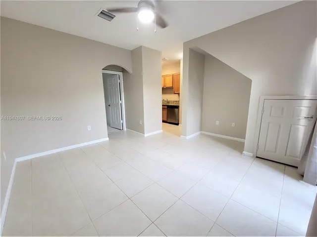 an empty room with windows and cabinet