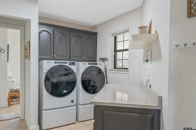 a utility room with sink dryer and washer