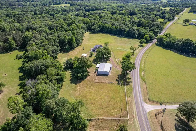 an aerial view of a house with a swimming pool