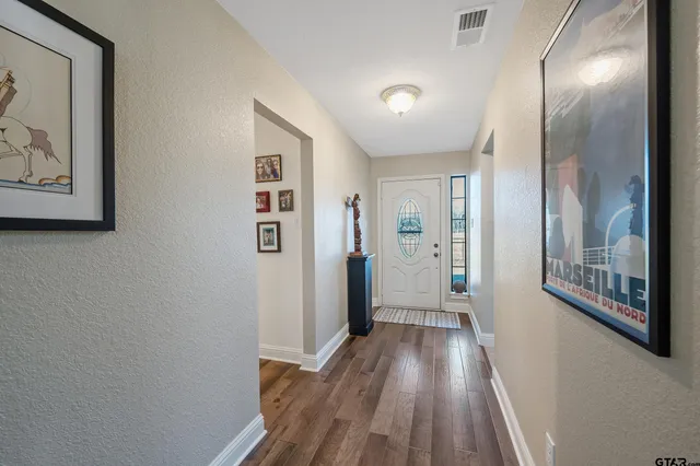 a view of hallway with wooden floor