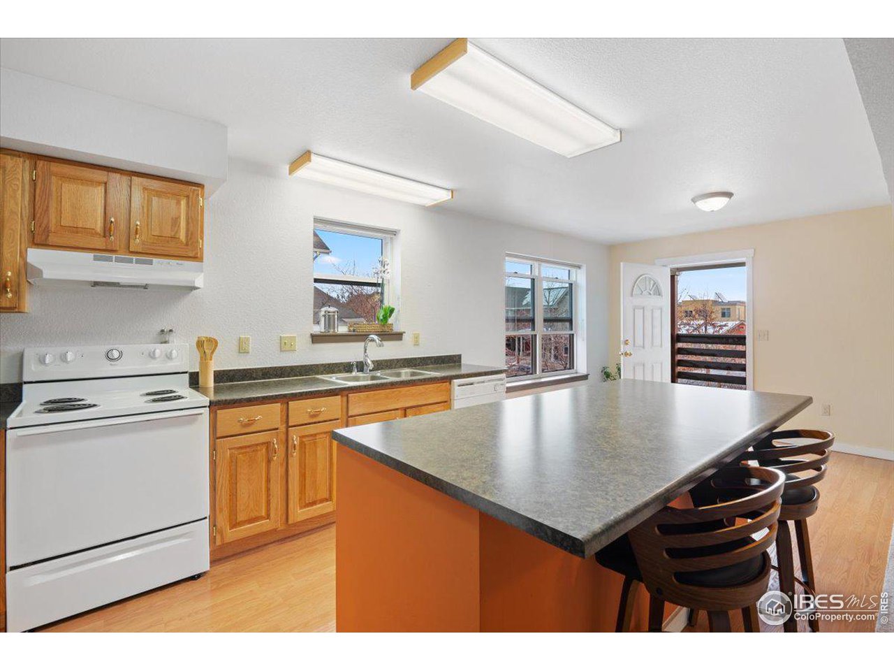 4625 16th Street, Unit 4 Boulder, CO 80304 - Photo 4 of 11 a kitchen with stainless steel appliances granite countertop a stove a sink dishwasher and cabinets with wooden floor