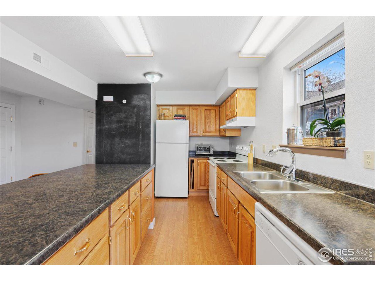 4625 16th Street, Unit 4 Boulder, CO 80304 - Photo 5 of 11 a kitchen with stainless steel appliances granite countertop a sink stove and refrigerator