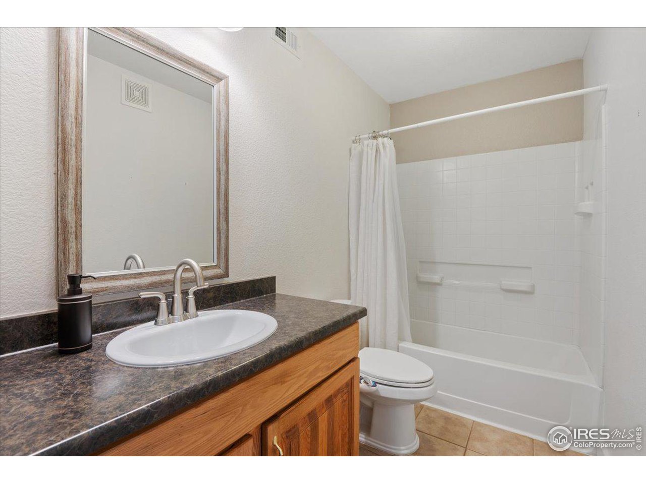 4625 16th Street, Unit 4 Boulder, CO 80304 - Photo 9 of 11 a bathroom with a granite countertop sink toilet and shower