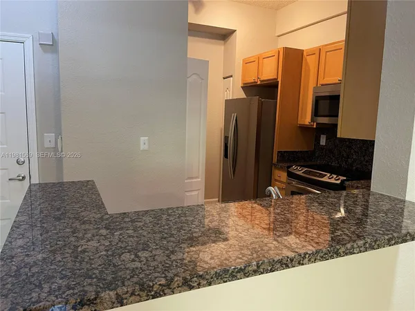 a kitchen with a refrigerator and a stove