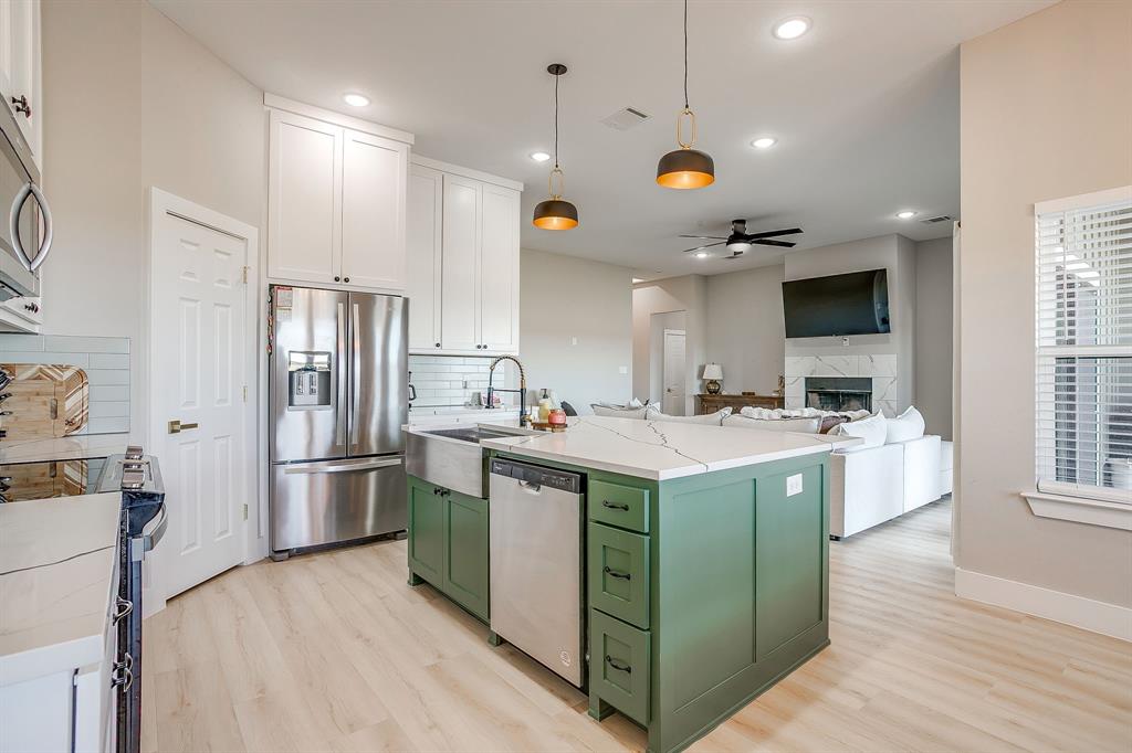 920 Kite Road Mineral Wells, TX 76067 - Photo 11 of 30 a kitchen with kitchen island a sink stove and refrigerator