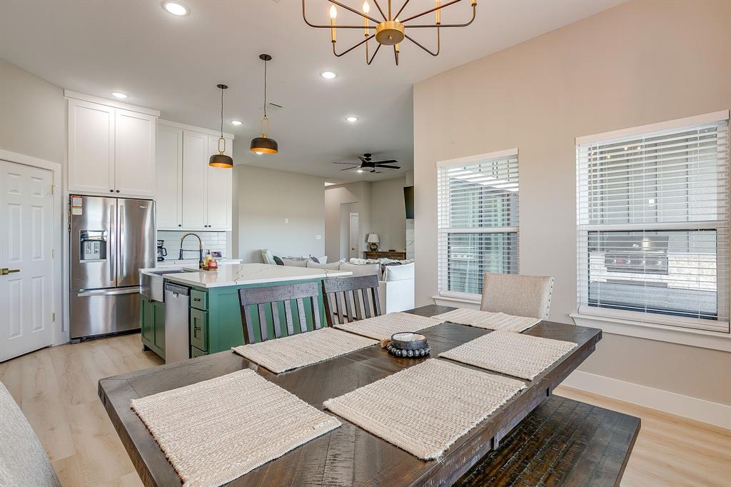 920 Kite Road Mineral Wells, TX 76067 - Photo 13 of 30 a kitchen with a table chairs and refrigerator